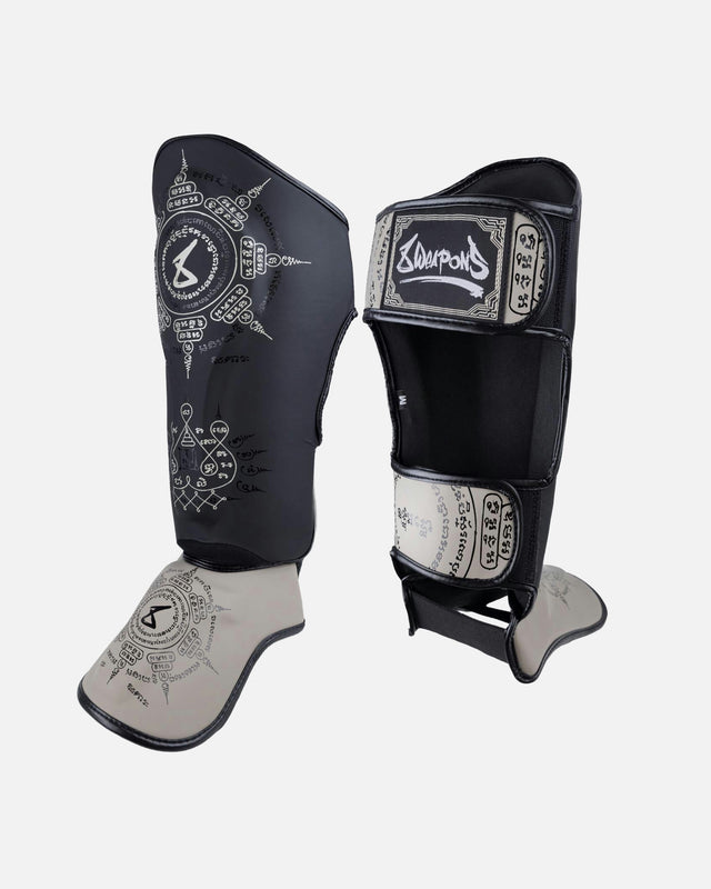Espinilleras 8 WEAPONS 8 Ways Yant – Negro/Arena