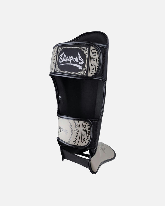 Espinilleras 8 WEAPONS 8 Ways Yant – Negro/Arena