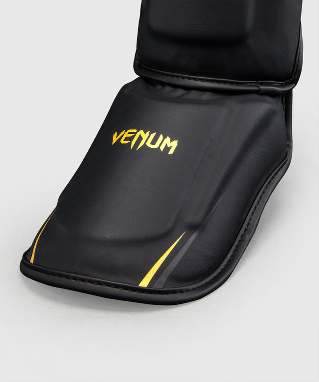 Espinilleras Venum G-Core – Negro/Oro