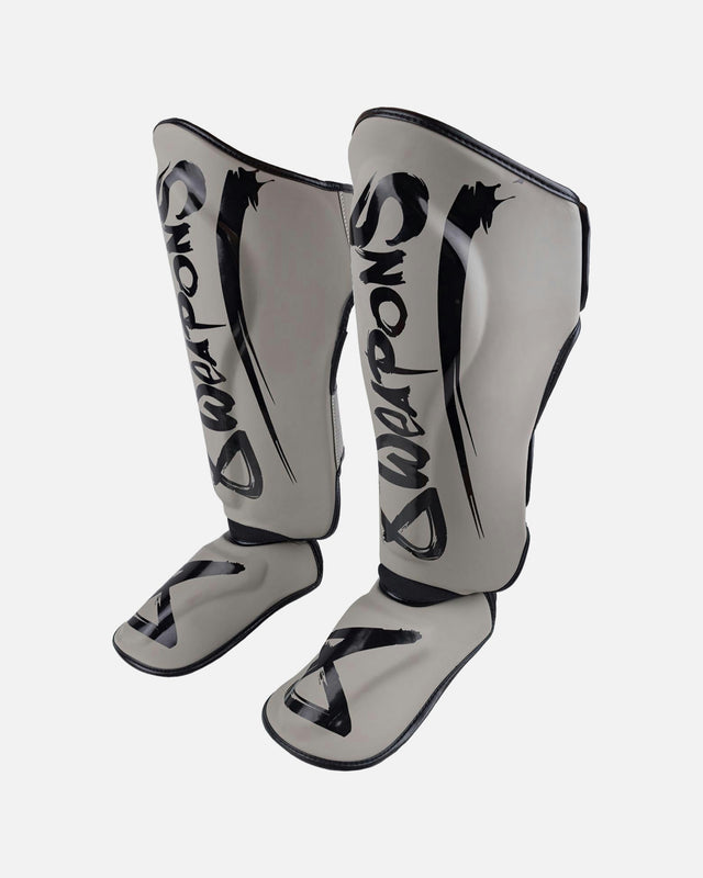 Espinilleras 8 WEAPONS Unlimited 2.0 – Arena/Negro