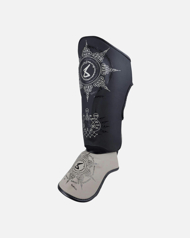 Espinilleras 8 WEAPONS 8 Ways Yant – Negro/Arena